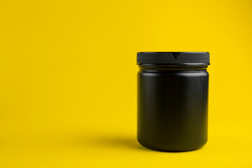 Cosmetics containers mockup. Jar or blank packaging for cosmetic product with cap on a yellow background. Beauty products for body care. Space for text.