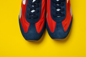 A pair of new youth sneakers on a yellow background.  Lifestyle sneaker sport shoe.