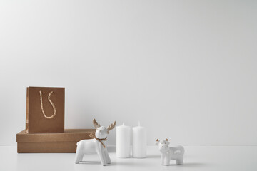Fototapeta na wymiar Porcelain figurine of a deer and a bull and New Year's, festive decor. Copy space, mock up.