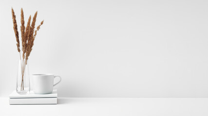 Mug and transparent vase with flowers on a white background. Eco-friendly materials in the decor of the room, minimalism. Copy space, mock up