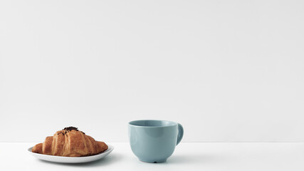 Obraz na płótnie Canvas Mug and croissants on a white background. Eco-friendly and natural materials in the decor, dessert. Copy space, mock up