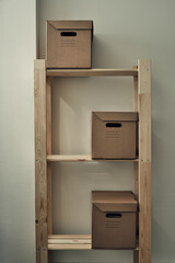 Paper boxes are on a wooden rack. Archive storage, use of eco-friendly materials