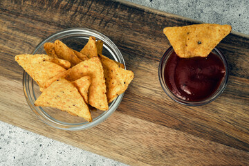 Corn cheese, snacks with sauce on a wooden stand. Beer snack, dish on the menu. Close up.