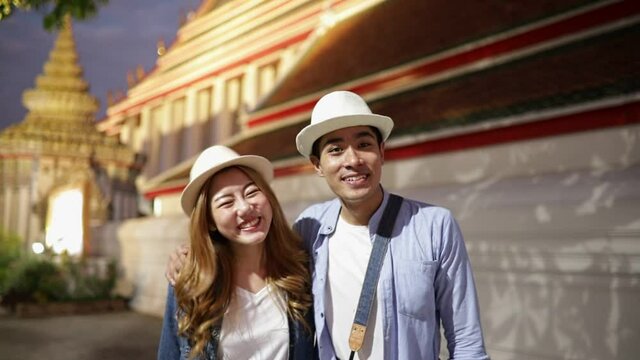 Traveler Asian couple travel in temple Bangkok, Thailand, sweet couple  spending holiday trip in sunset. Lifestyle couple travel in city concept.Young fun happy Asian tourist backpacker travel.
