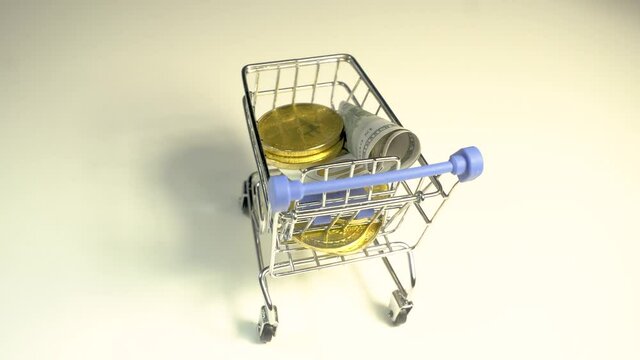 Bitcoin coins on shopping cart with ground full of dollar. Digital economy investment concept.