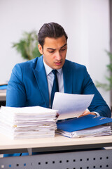 Young businessman employee reading contract in the office