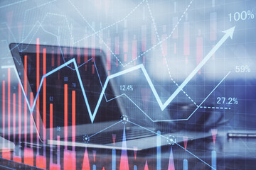 Stock market graph and table with computer background. Double exposure. Concept of financial analysis.