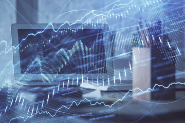 Forex market graph hologram and personal computer on background. Double exposure. Concept of investment.