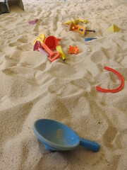 Fototapeta na wymiar there are many trunks full of sand and all kinds of toys in the Children's bunker for the joyful concept of sandpit 