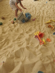there are many trunks full of sand and all kinds of toys in the Children's bunker  for the joyful concept of sandpit 