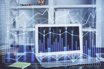 Financial chart drawing and table with computer on background. Double exposure. Concept of...