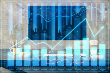 Double exposure of graph and financial info and work space with computer background. Concept of international online trading.