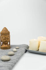 Gray zen pebble hot stones with towel on massage table in beauty salon. Hot stone massage setting. Concept set of harmony, balance and meditation, spa, relax, spa treatment