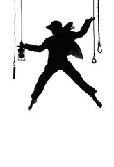 A female dancer dances on stage. Dressed in men's 
clothing and wearing a man's hat, she is seen leaping 
in mid air as a silhouette.