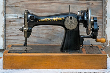 Vintage sewing machine. Retro. Sewing history. Close-up details. Cover, elements and details of a sewing machine close-up. Macro photo.