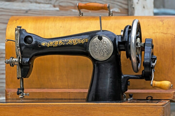 Vintage sewing machine. Retro. Sewing history. Close-up details. Cover, elements and details of a sewing machine close-up. Macro photo.