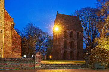 Westerstede, Germany - November 09, 2020: medieval bell tower of the church "St. Petri" during dawn