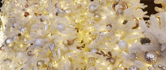 Christmas  balls on the evergreen tree. New year background with lights