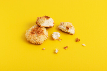 Homemade dietary sugar-free coconut cookies on yellow background.
