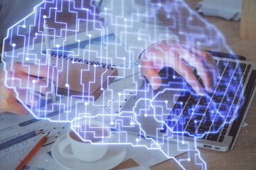 Businessman with computer background with brain theme hologram. Concept of brainstorm. Multi exposure.