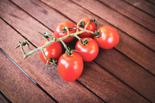 red tomatoes on wood background
