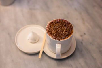 Blurred background view Of the beverage menu with chocolate powder sprinkled on top, placed in a white glass and placed for customer service