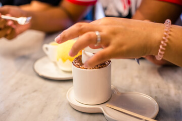 Blurred background view Of the beverage menu with chocolate powder sprinkled on top, placed in a white glass and placed for customer service