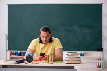 Young male student preparing for exams in the classroom