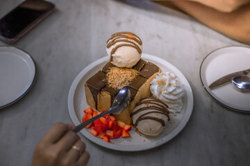 Blurred background view Of the dessert menu (Honey Toast) that contains ice cream, whipped cream, sour fruit like strawberries to be decorated and served to the customer.