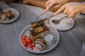 Blurred background view Of the dessert menu (Honey Toast) that contains ice cream, whipped cream, sour fruit like strawberries to be decorated and served to the customer.