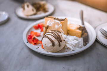 Blurred background view Of the dessert menu (Honey Toast) that contains ice cream, whipped cream, sour fruit like strawberries to be decorated and served to the customer.