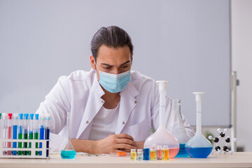 Young male chemist working in the lab