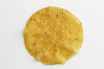Cirspy garlic and coriander Indian papadum on white background

