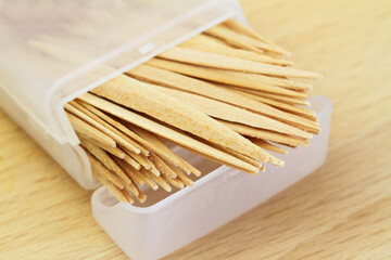 Wooden toothpicks in transparent plastic box
