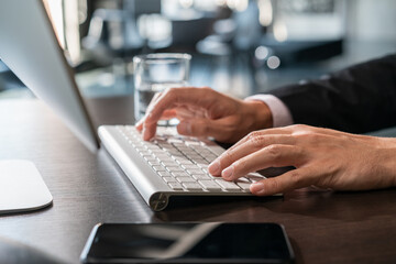 Office manager male hands typing on computer keyboard, closeup. Businessman working, typing on the wireless keyboard, no face, concept of work