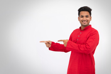 Indian man indicating with fingers, copy space