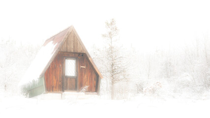 An abandoned cabin in foggy and snowy morning.