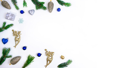 Pattern made from Christmas toys and fir branches isolated on a white background with copy space in the center.