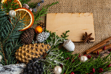 New Year and Christmas composition, wooden greeting card on a burlap background. Flat lay, copy space, top view