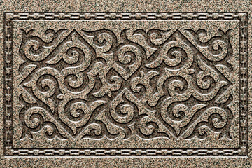 Ornamental print on the stone surface. Vintage ornament on the stone. Close-up seamless texture. Stone texture. Pattern on the stone. Embossed pattern. Wallpaper.