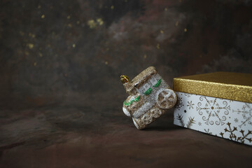 Christmas or New Year background. Glitter train toy on gift box on dark background