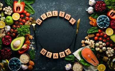 Healthy food for heart health: vegetables, fruits, nuts and other dietary foods. Top view. Free copy space.