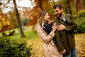 Young couple walking in the autumn park
