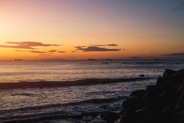 Obraz premium Sea rocks and blue sea and sunrise in Odessa on the beach