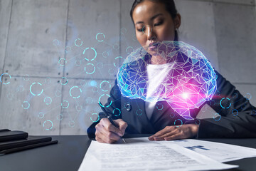 A woman signs contract and brain icon hologram. Multiexposure. International business.