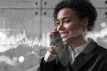 Businesswoman speaks phone and stock market financial chart hologram. Double exposure. Online trading bonds, shares and currencies concept.