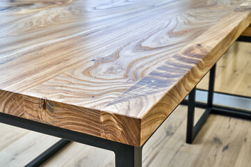 Live edge elm desk with metal base in a modern home office. Details close-up