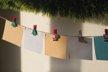 Garland of colored
leaflets for notes on New Year's clothespins.