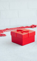 Red gift box on white minimalistic background