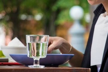 The girl is having breakfast in a cafe